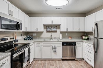 White Cabinetry with Stainless Steel Appliances